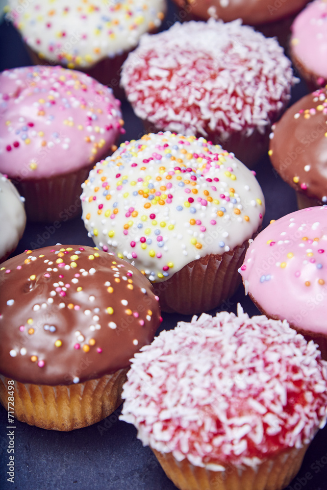 Colorful cupcakes on black slate Colorful cupcakes on black slate