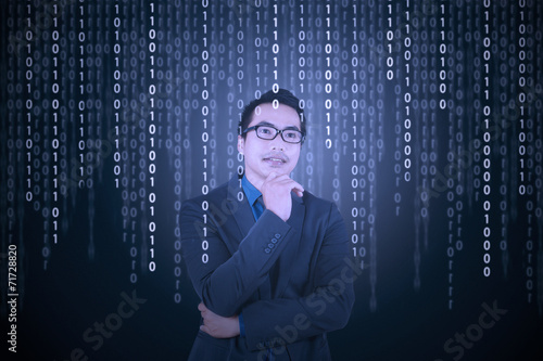 Thougthful businessman with binary code