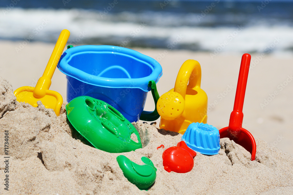 Plastic children toys on the sand beach Plastic children toys on the sand beach