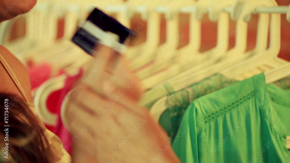 Happy woman getting credit card in the boutique Happy woman getting credit card in the boutique