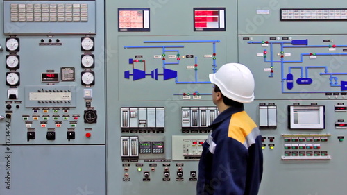 engineer checks light indication on main panel of station