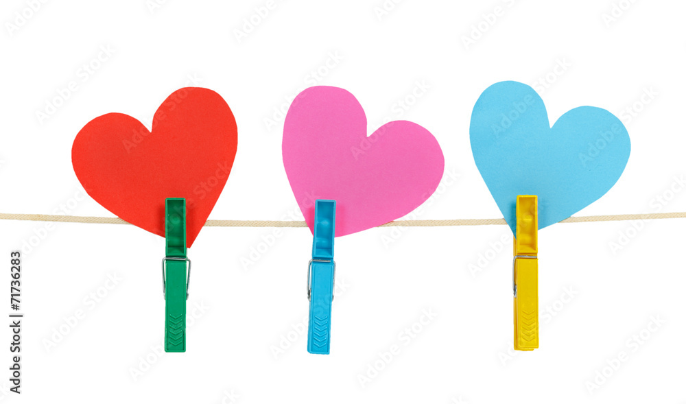 Three paper hearts on clothespins on a rope Three paper hearts on clothespins on a rope