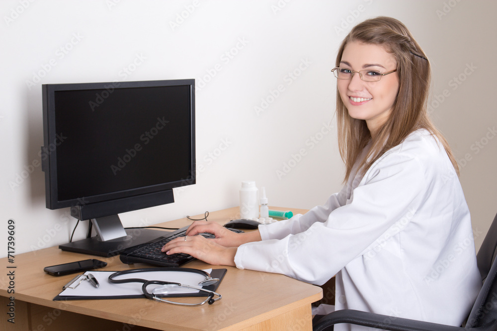 young woman doctor working with computer in office young woman doctor working with computer in office