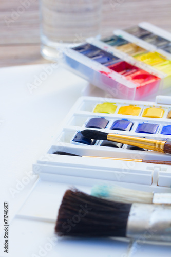 set of watercolor paints with brushes