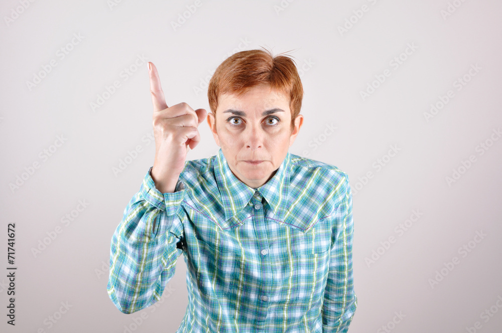 Angry threatening woman with a raised index finger Angry threatening woman with a raised index finger