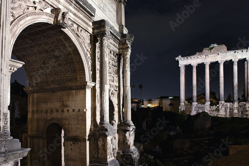 Roman Forum by night Arch of Titus, Temple of Saturn in Rome photo