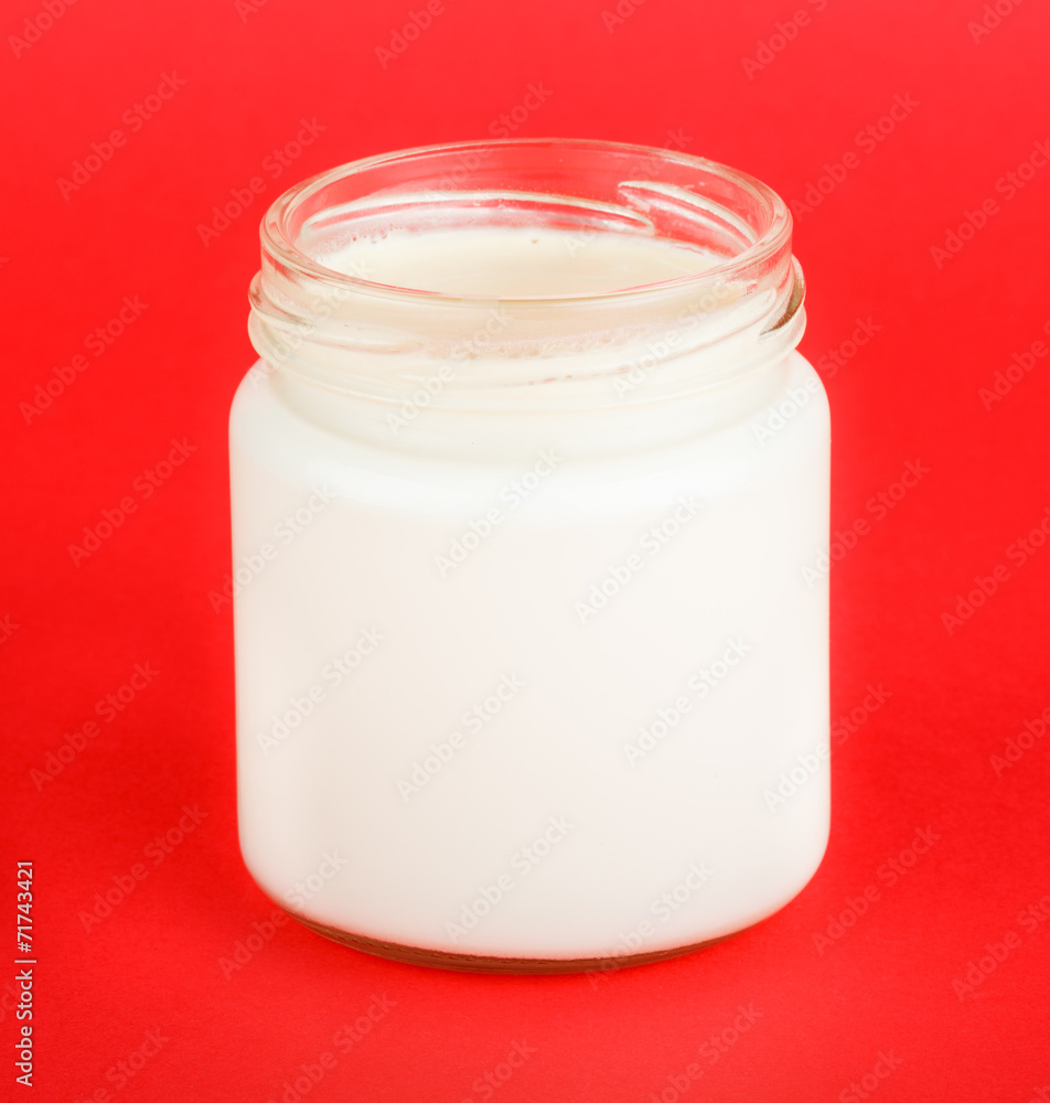 jar with yogurt isolated on red background jar with yogurt isolated on red background