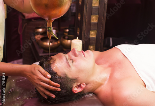 man engaged in Ayurvedic spa treatment