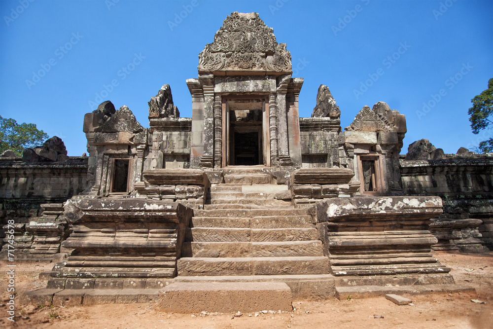 Naklejka premium The ancient ruins of a historic Khmer temple in the temple compl