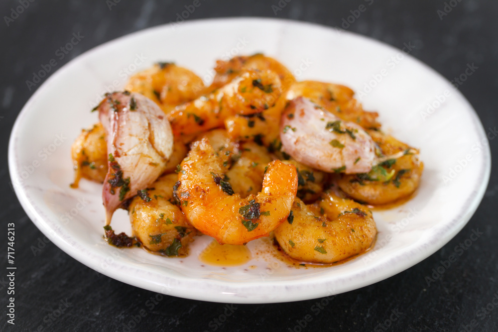 shrimps with garlic and herbs on plate