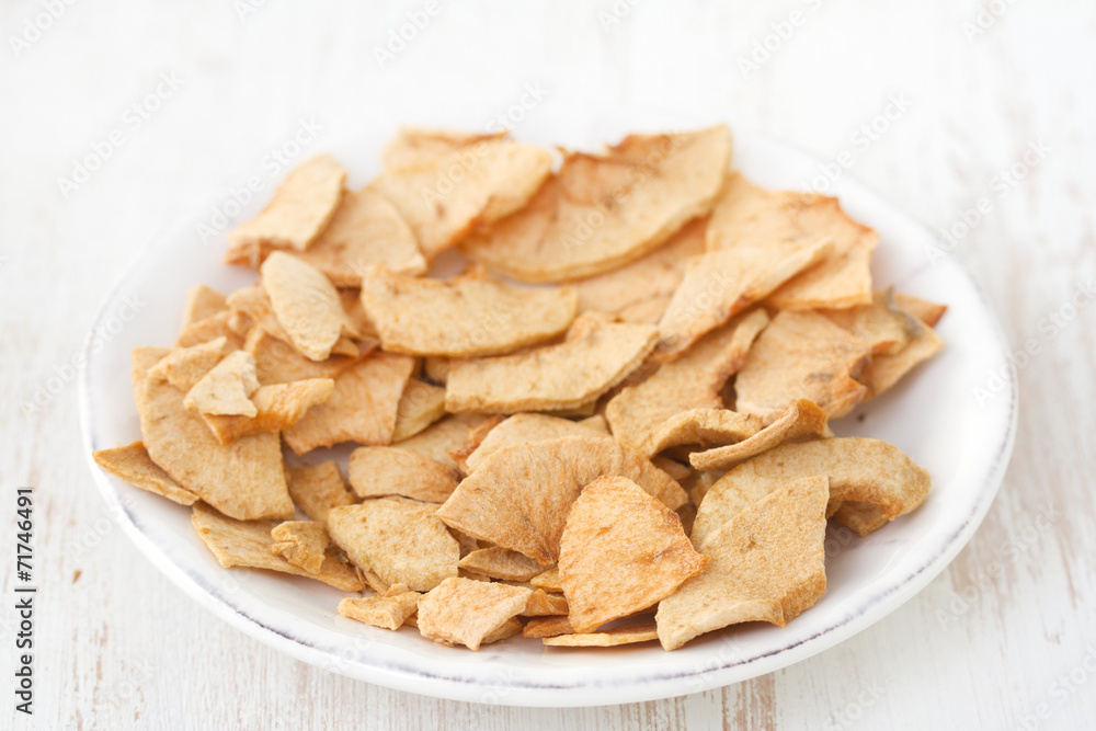 dried apples on plate on white background dried apples on plate on white background