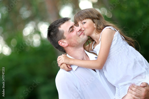 portrait of a happy family in summer nature