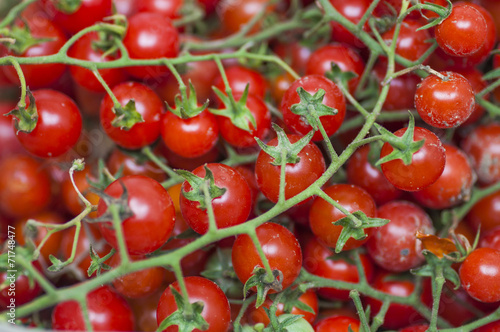 Some red cherry tomatoes in wooden background