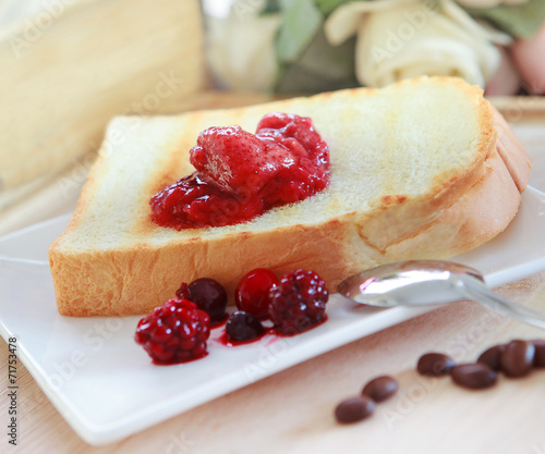 toast bread and strawberry jam on white plate