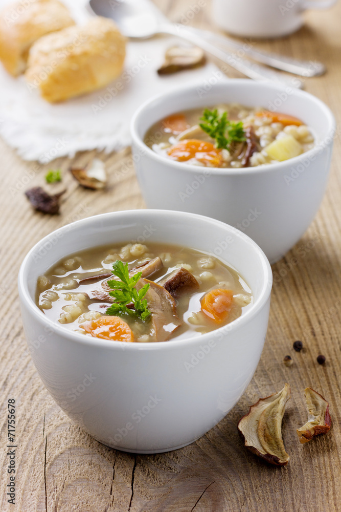 Mushroom soup with barley and vegetables in white plate Mushroom soup with barley and vegetables in white plate