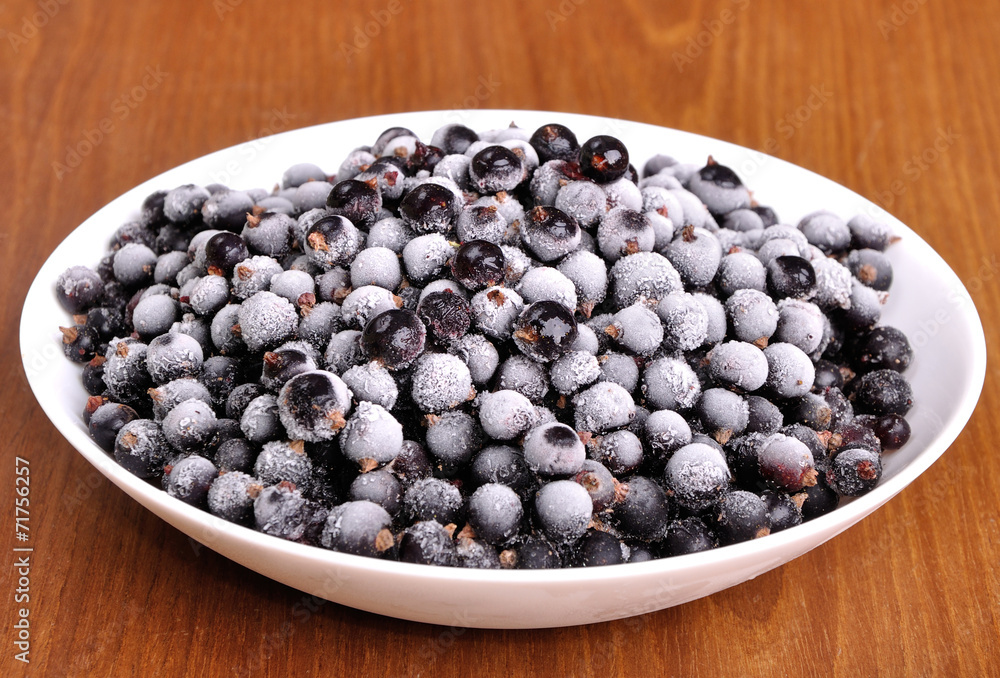 heap of frozen black currant in a plate heap of frozen black currant in a plate