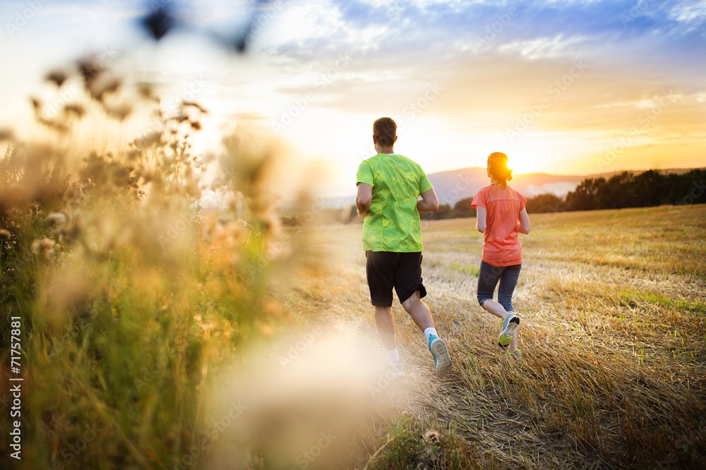 Couple running at sunset