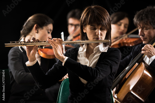 Symphony orchestra performance: flutist close-up