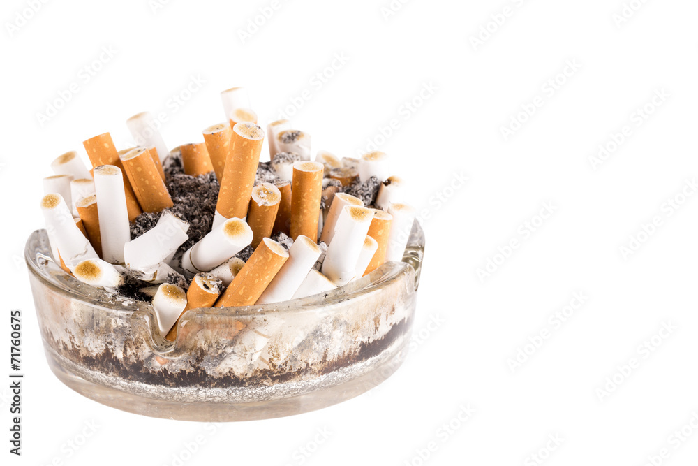 A dirty ashtray with cigarette ash and butts A dirty ashtray with cigarette ash and butts