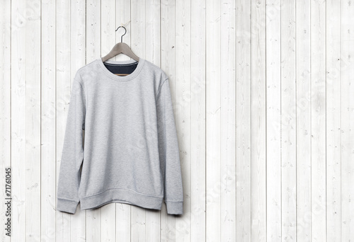 Sweater on a white wood wall