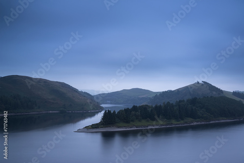 Moody landscape image of lake pre-dawn in Autumn with haunting f