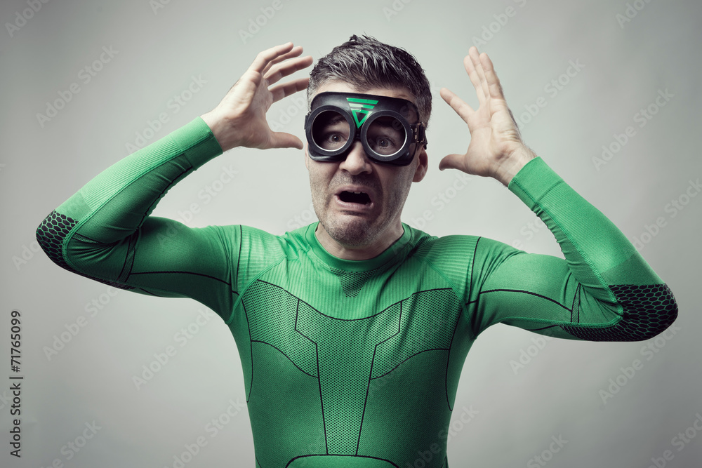Terrified superhero with hands raised Terrified superhero with hands raised
