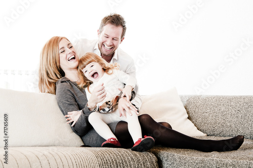 Mother, father and daughter on Sofa