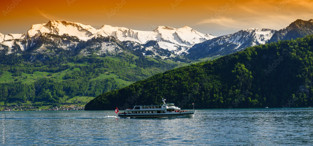 Pleasure boat with tourists on the lake, view from the side. Lake Lucerne. Swiss.