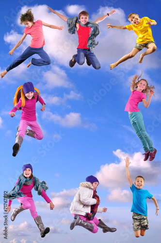 happy children exercising and jumping in the blue sky