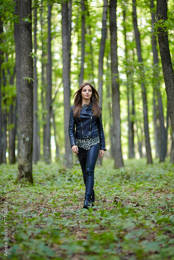 Teenage girl walking in the forest park
