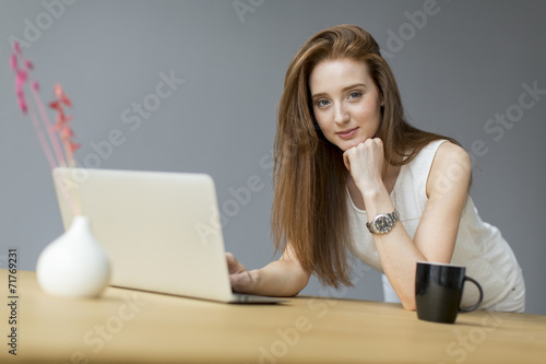 Young woman with laptop in ...