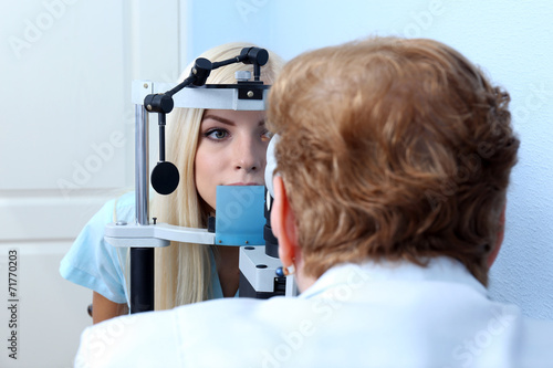 Fototapeta Naklejka Na Ścianę i Meble -  Optometry concept - pretty young woman having her eyes examined