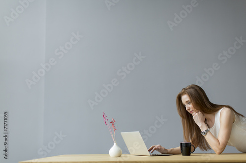 Young woman with laptop in ...