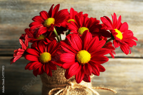 Fototapeta Naklejka Na Ścianę i Meble -  Beautiful chrysanthemum in vase on wooden background