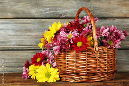 Fototapeta Naklejka Na Ścianę i Meble -  Beautiful chrysanthemum in basket on wooden background