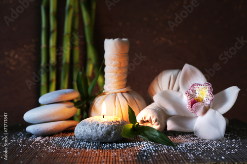 Fototapeta Naklejka Na Ścianę i Meble -  Spa set on bamboo mat on dark background
