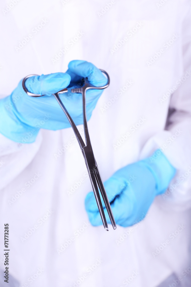 Surgeon's hands holding clip closeup Surgeon's hands holding clip closeup