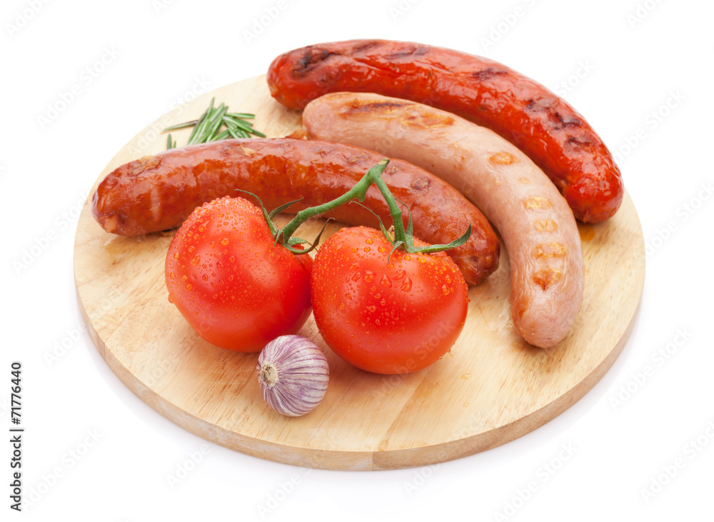 Various grilled sausages with condiments and tomatoes Various grilled sausages with condiments and tomatoes