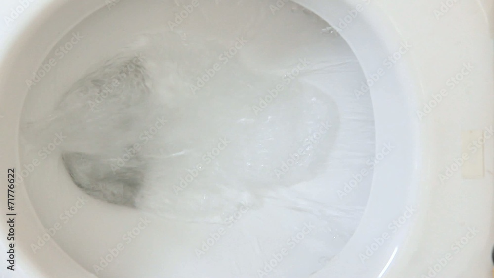 Closeup view of a flushing white toilet Closeup view of a flushing white toilet