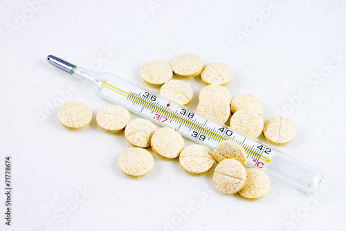 Thermometer and pills for the flu