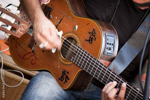 male hand touching the guitar