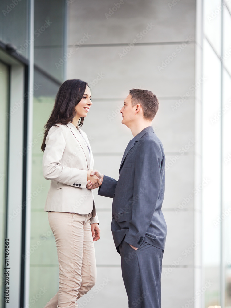 Two Business people shaking hands outdoors Two Business people shaking hands outdoors
