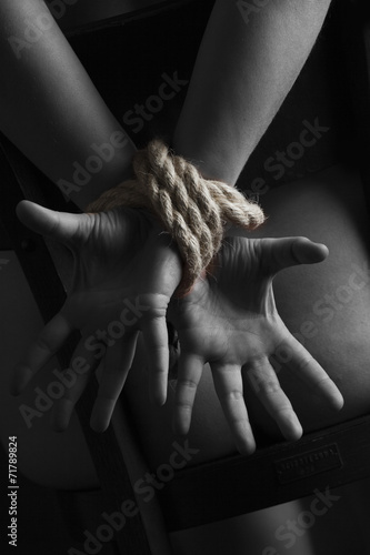 Nude submissive handcuffed woman, bondage act