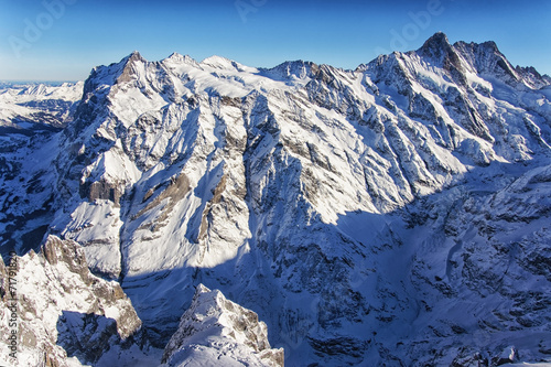 Jungfrau mountain wall in winter helicopter view