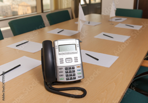 Phone on table in meeting room