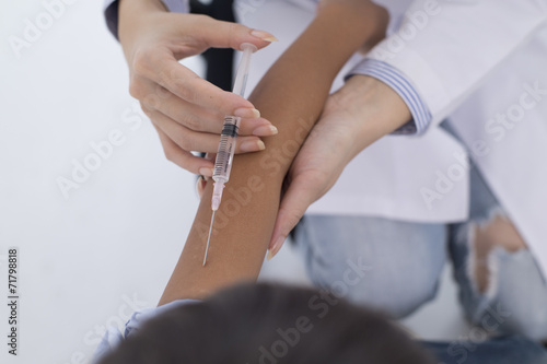 Children receive an injection in the arm