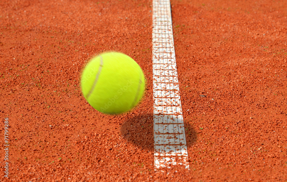 Tennis ball on a tennis clay court