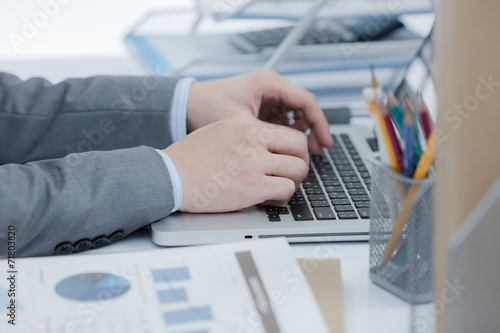 Businessman analyzing investment charts with laptop. Accounting