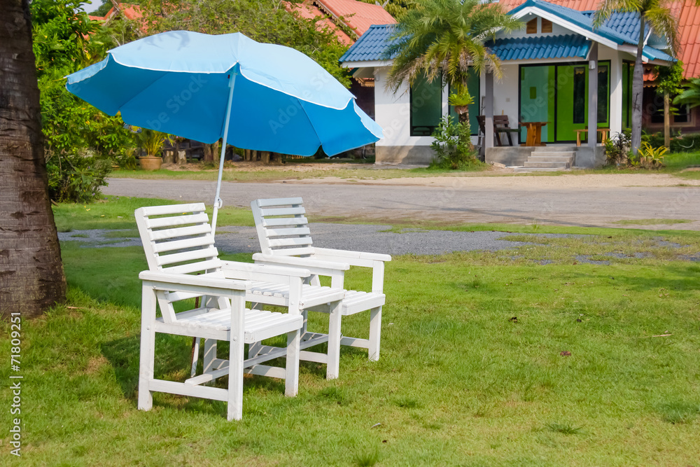 white chair set and umbrella on grass floor