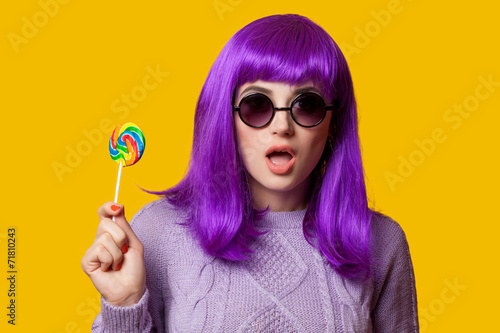 Surprised girl with violet hair on violet background.